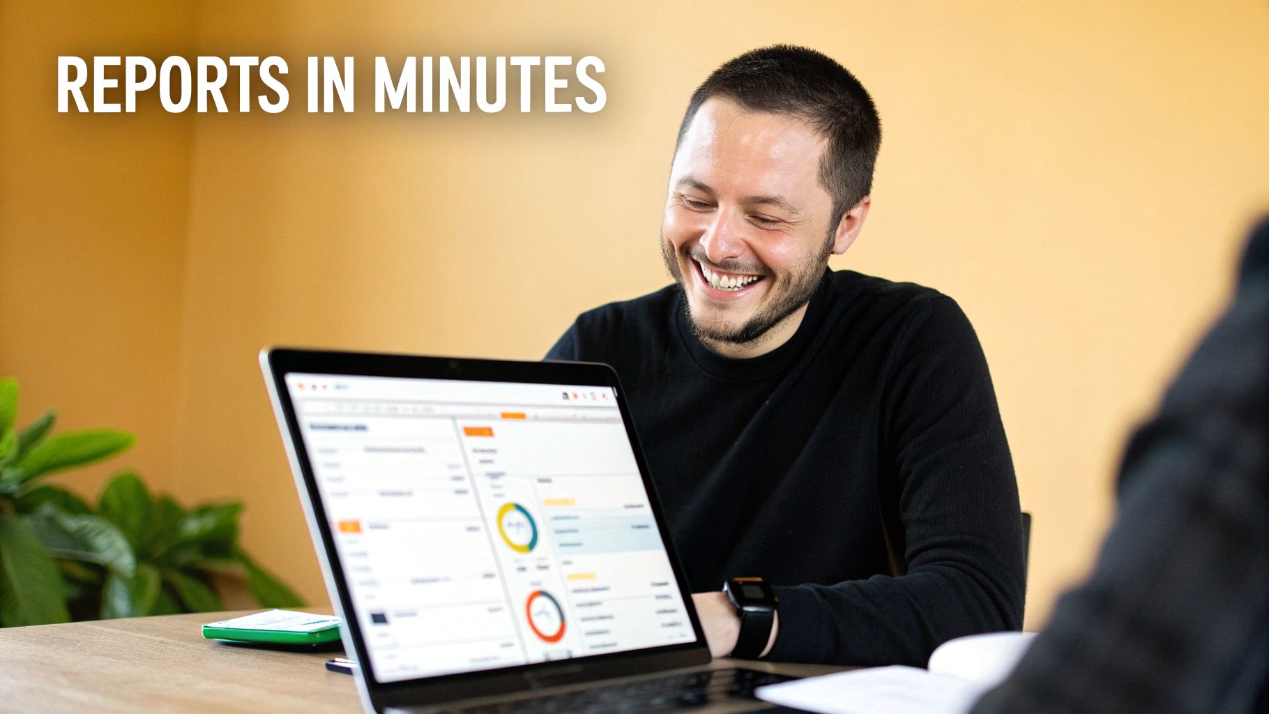 A smiling man views data reports and charts on a laptop screen, highlighting efficiency.