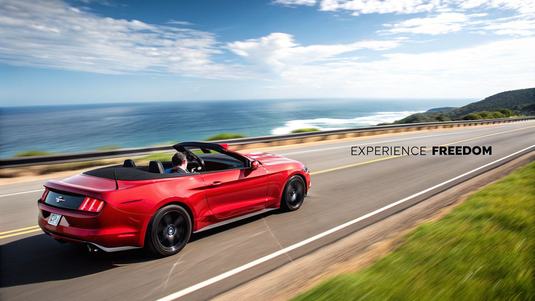 Red Mustang driving on a desert road with mountains in the background