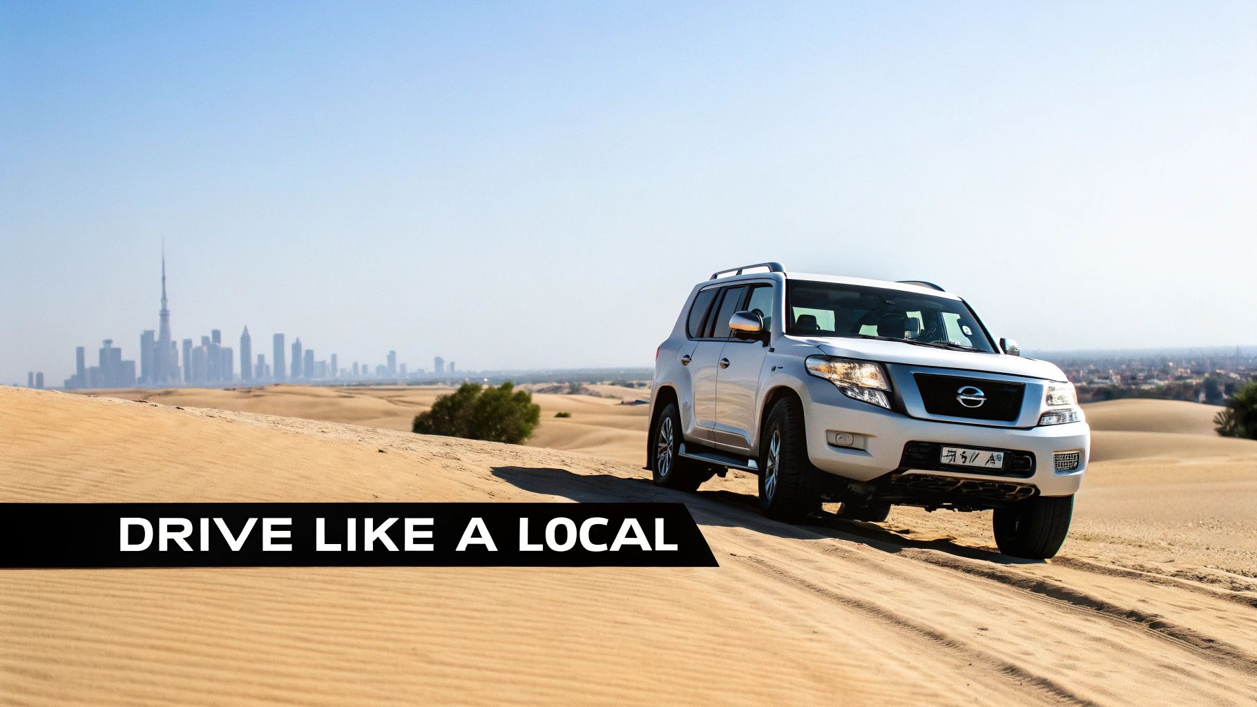 Your Guide to Rent a Car Nissan Patrol in Dubai 4 A silver Nissan Patrol SUV drives on desert sand dunes with the Dubai skyline visible.