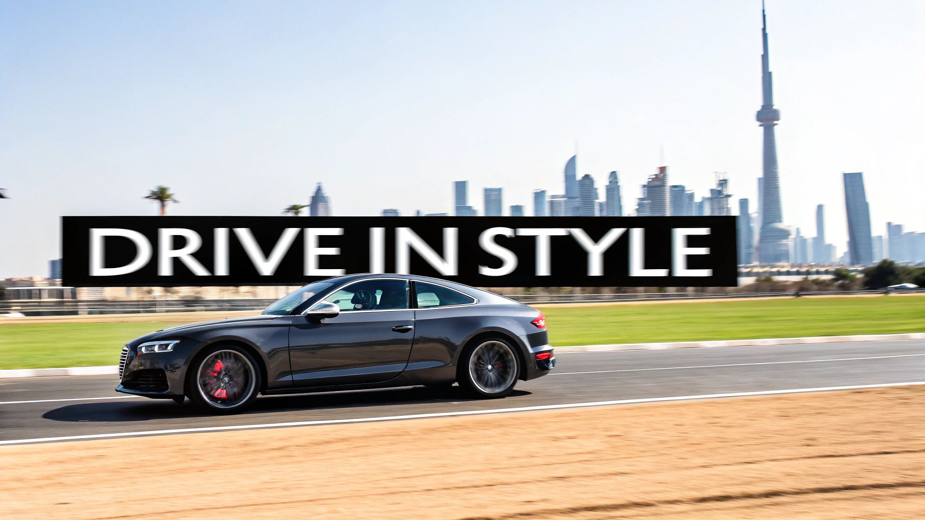 A sleek grey Audi sports car drives on a track, with Dubai city skyline and "DRIVE IN STYLE" text.