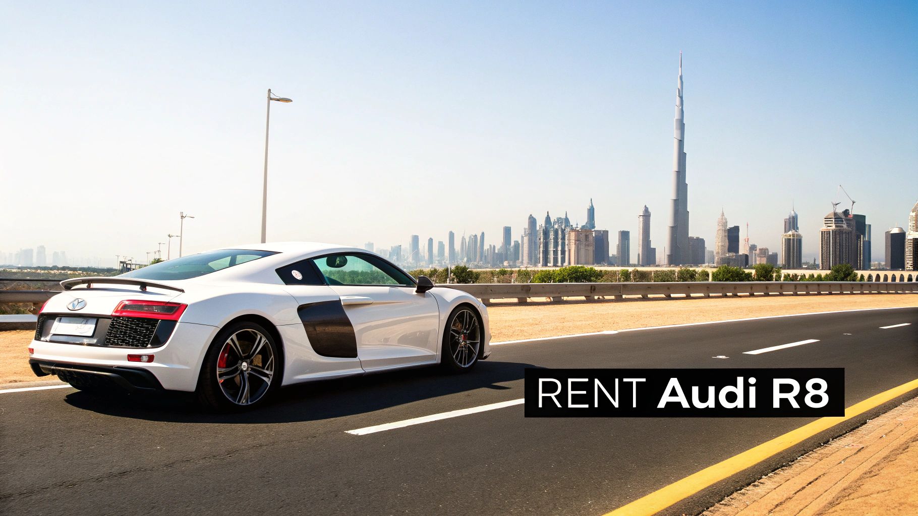 White Audi R8 sports car driving on a highway with the iconic Dubai skyline and Burj Khalifa in the background.