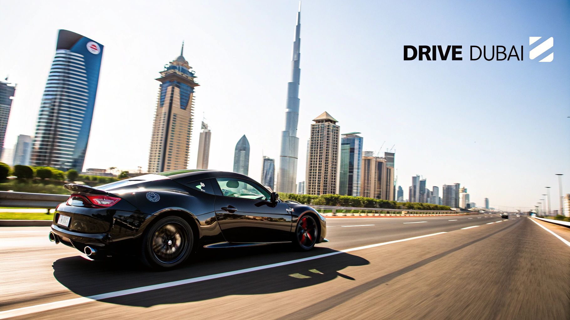 A black sports car drives on a highway in Dubai, with the prominent Burj Khalifa and city skyline.