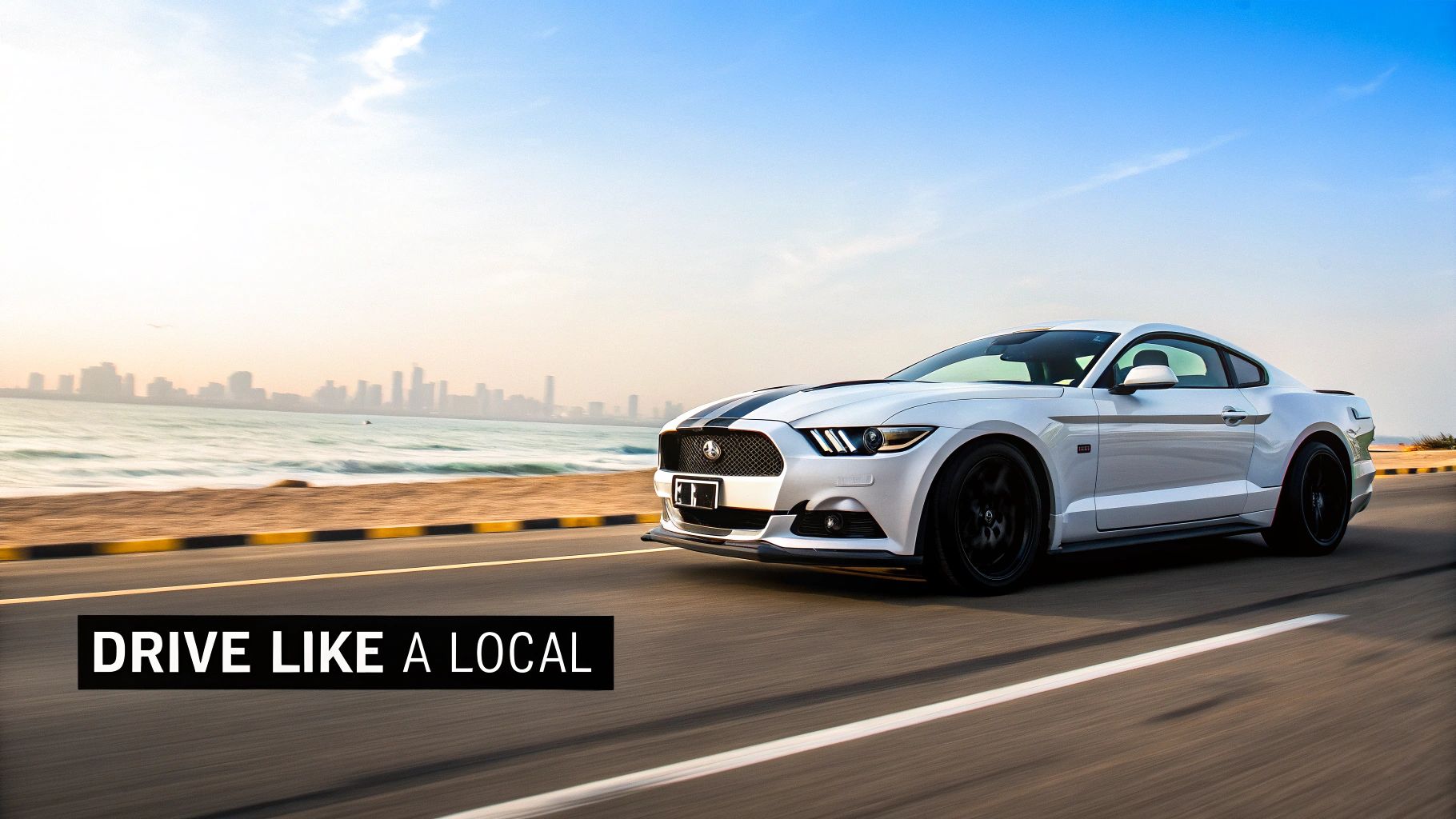 A person driving a yellow Mustang with the Dubai skyline in the background