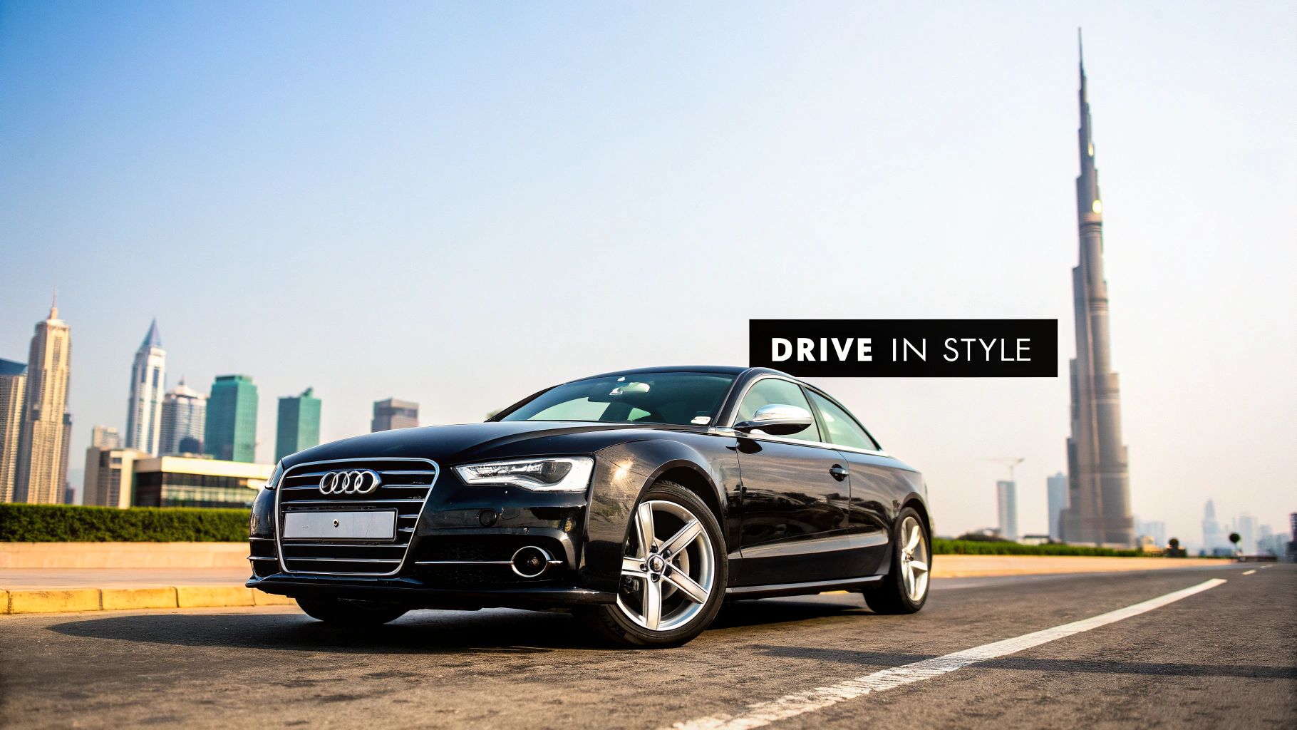 Audi Rent Dubai Your Ultimate Guide to Luxury Car Rentals 1 A sleek black Audi car is parked on a road in Dubai, with the iconic Burj Khalifa and city skyline in the background, promoting 'DRIVE IN STYLE'.