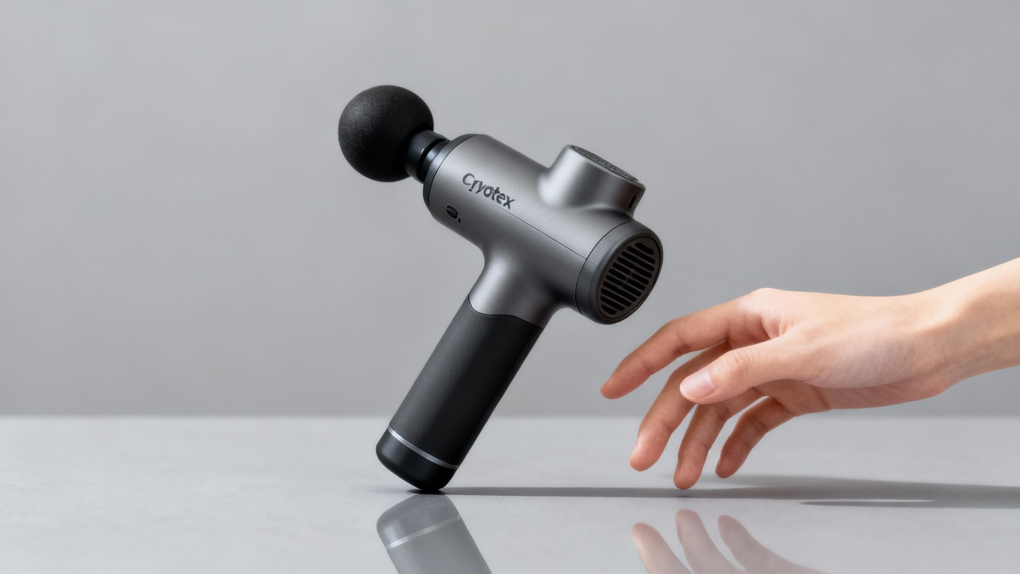 A close-up of the Cryotex deep tissue massage gun being used on a person's shoulder.