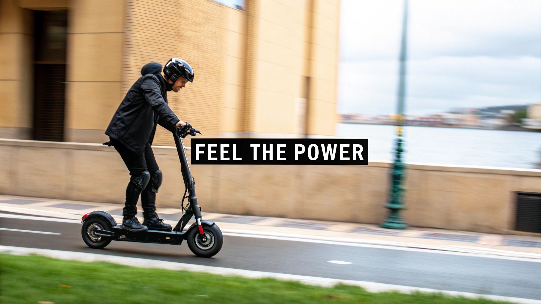 A person wearing a helmet and knee pads rides a black electric scooter on a paved road, feeling the power.