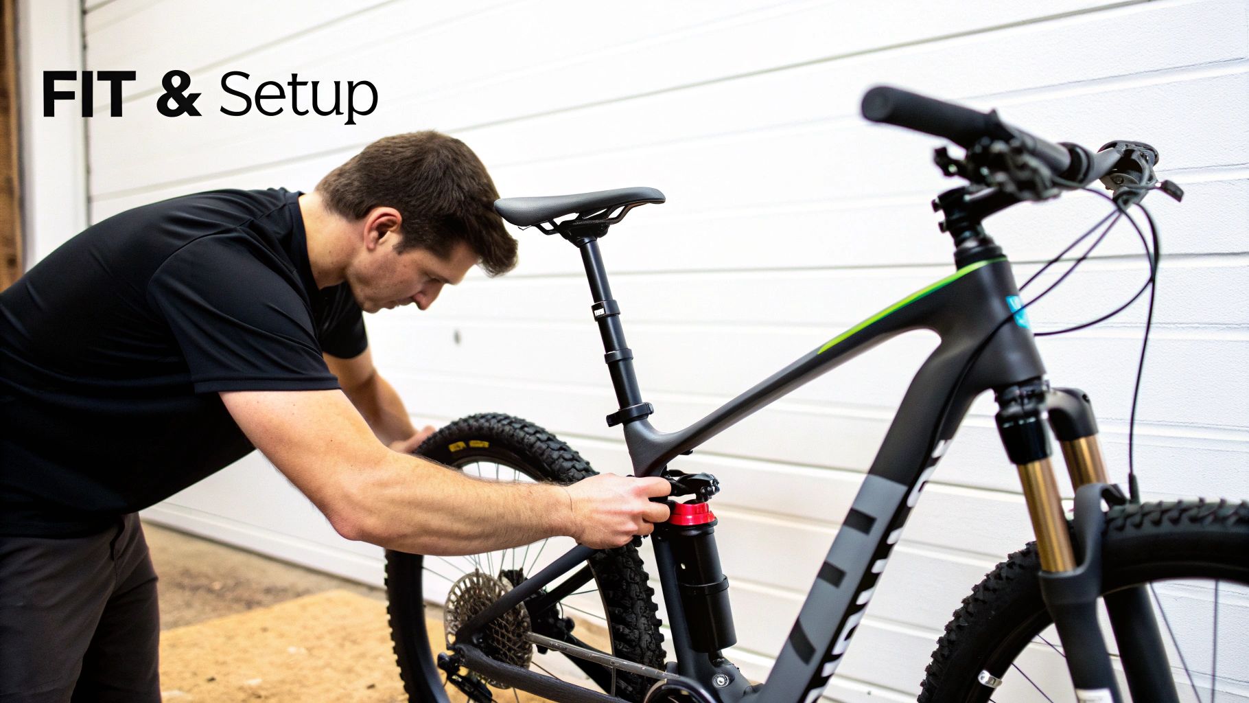 A man adjusts the seat and suspension of a black mountain bike, focusing on bike fit and setup.