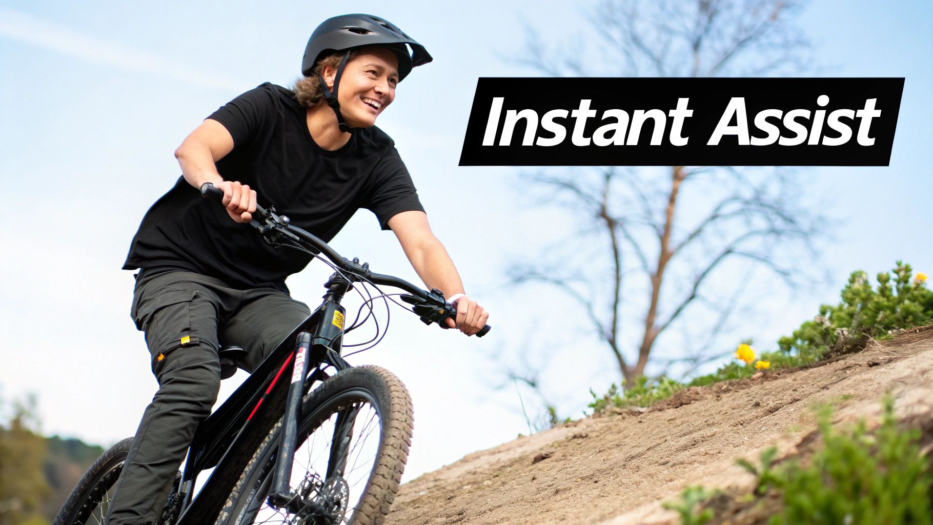 A person smiling while riding a Class 2 ebike through a city park.