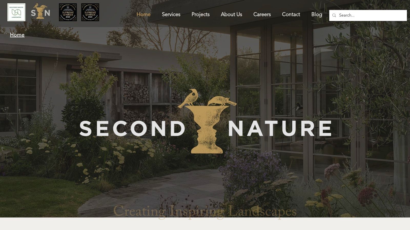 A lush, architecturally designed garden by Second Nature, featuring stone pathways, layered planting, and mature trees.