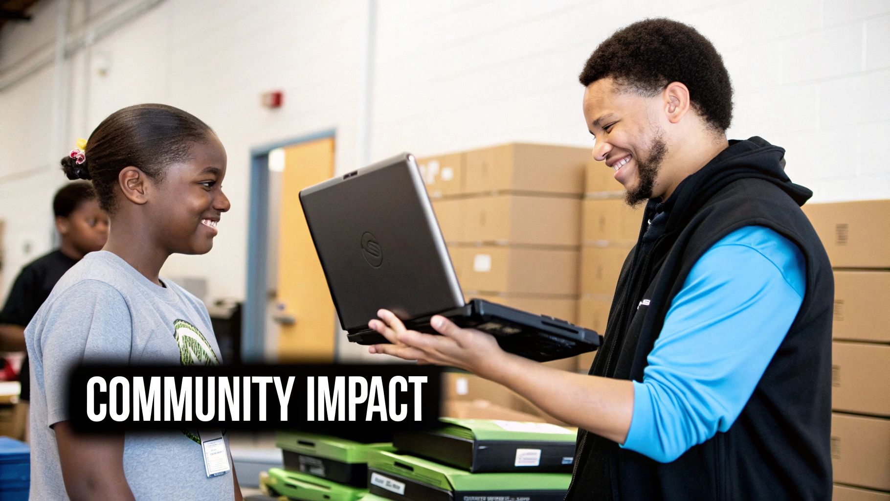 A smiling man shows an open laptop to a happy young girl in a community setting.