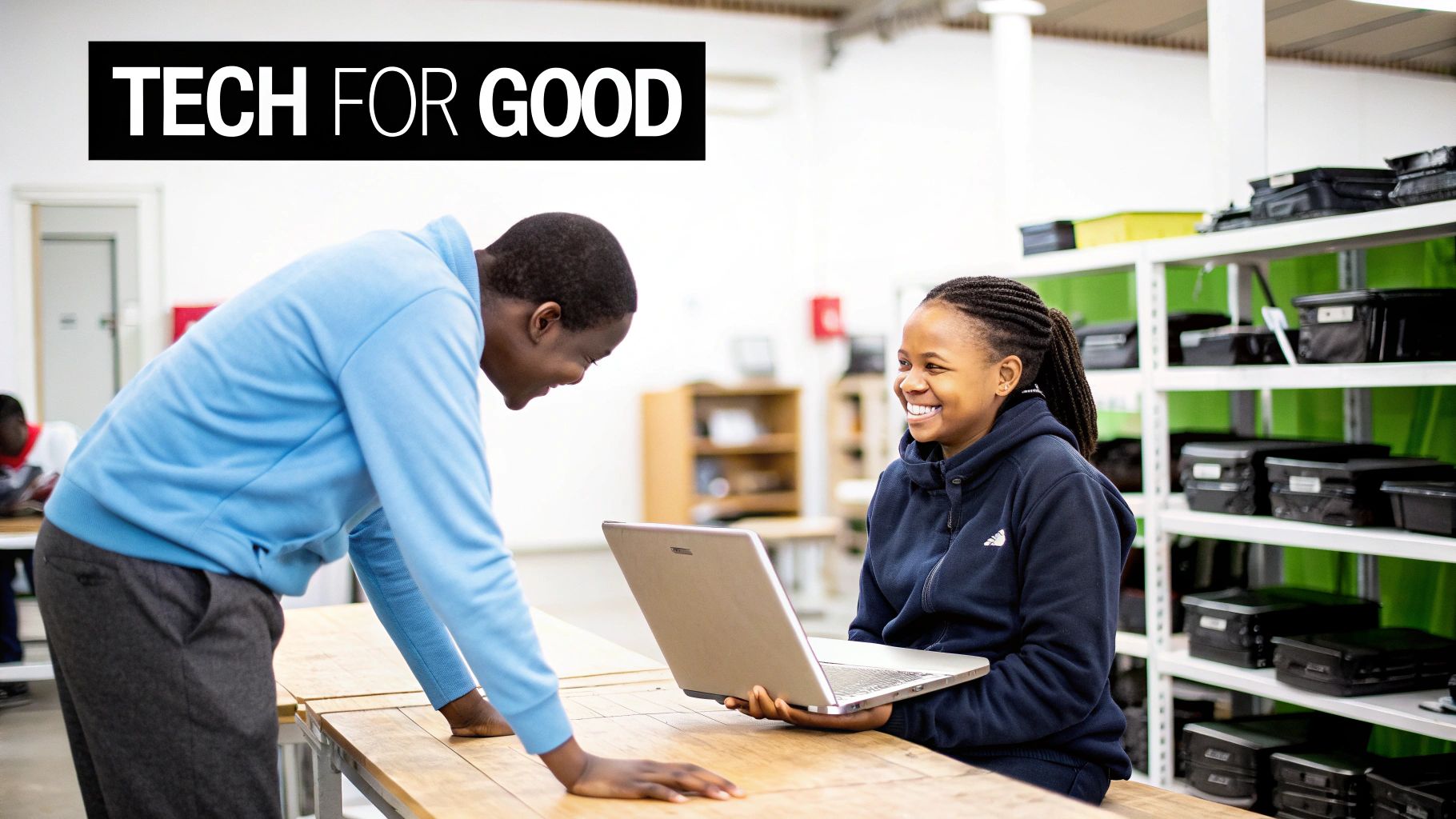 Group of smiling volunteers refurbishing laptops at a Reworx Recycling community workshop.