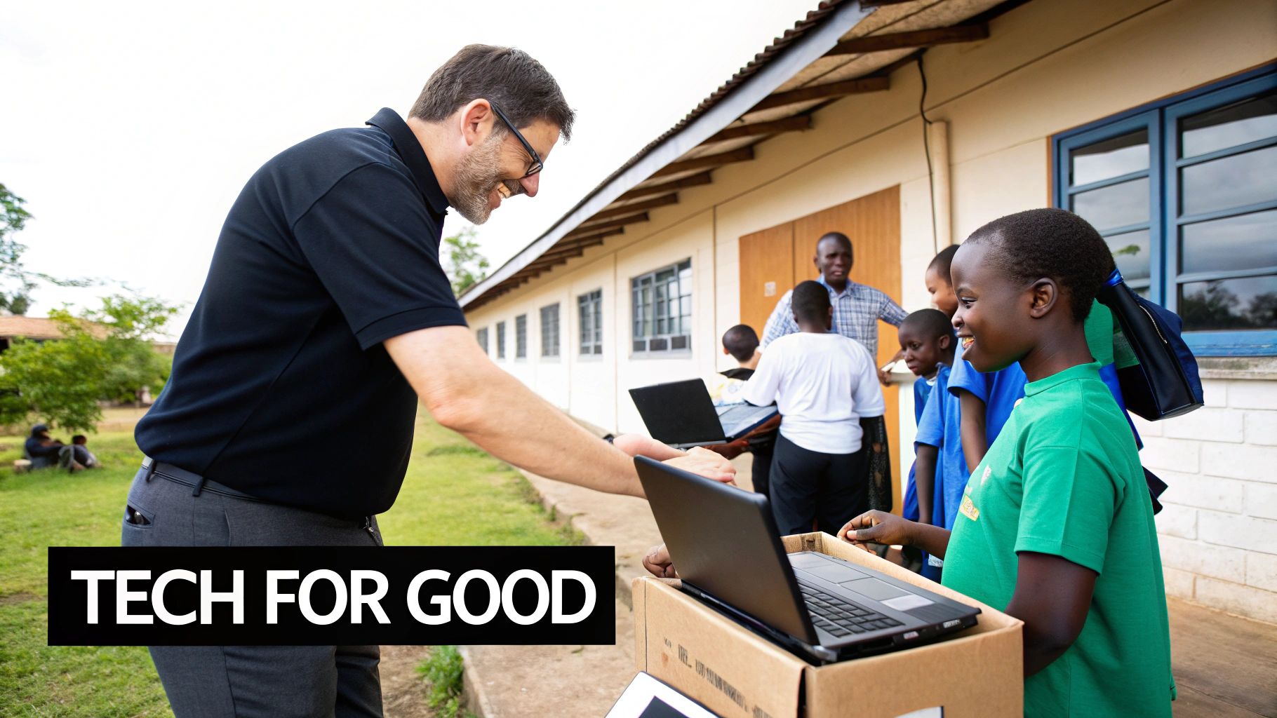 Man handing a laptop to a smiling child, emphasizing the theme "Tech for Good," showcasing Reworx Recycling's commitment to refurbishing and donating electronics to support local communities.