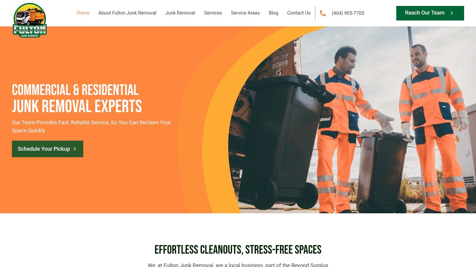 A professional junk removal team in uniform loading bulky items and bags of junk into a large branded truck.