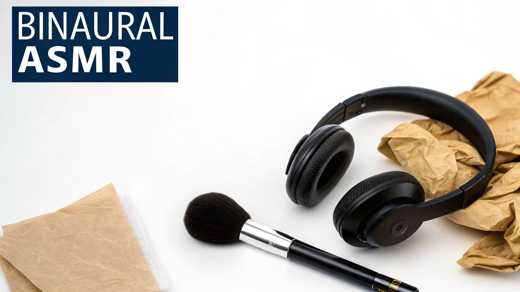 BINAURAL ASMR text in a blue box, with black headphones, a makeup brush, and crumpled paper on a white surface.