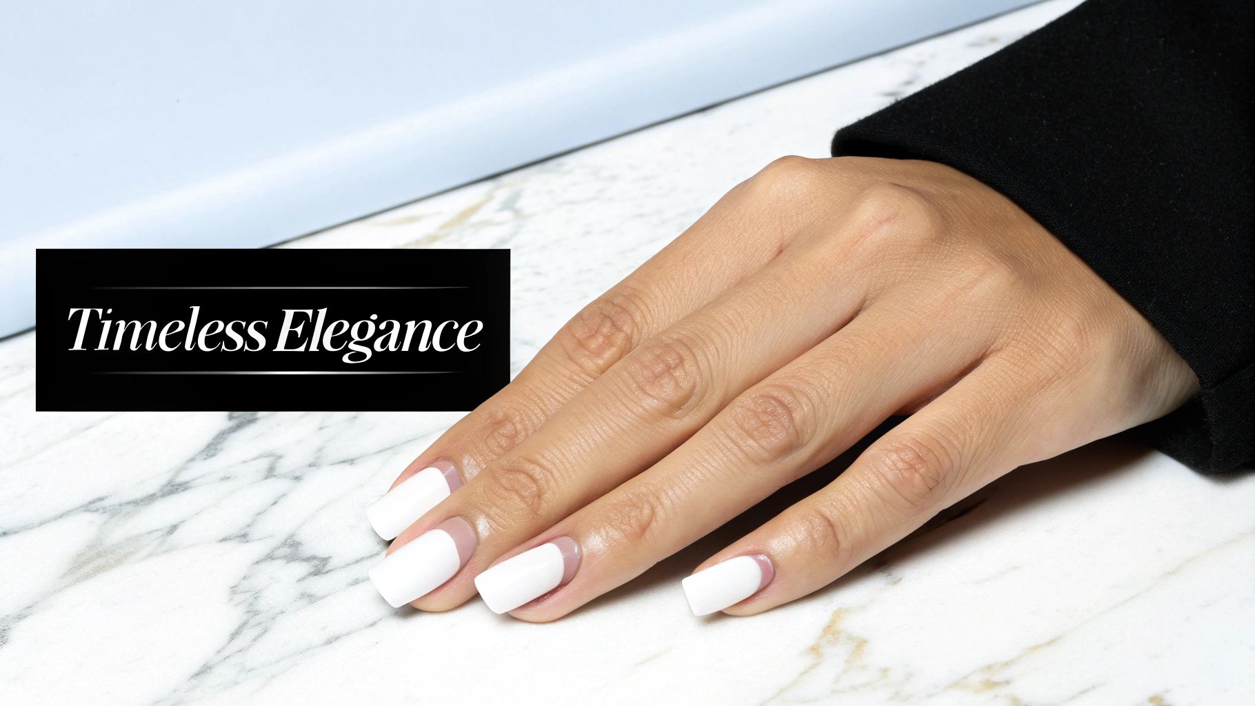 A hand with elegant white French gel nails rests on a luxurious marble surface, showcasing timeless beauty.