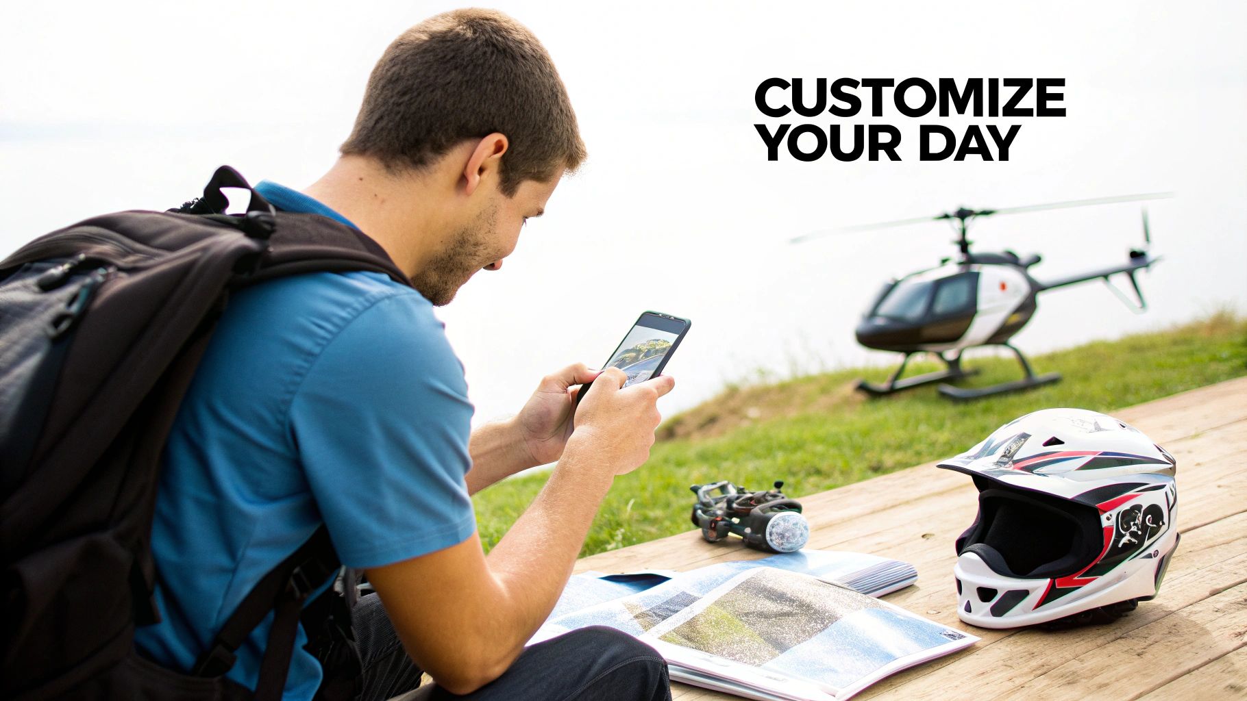 A man uses a smartphone to customize his day, surrounded by a helmet and model helicopter.