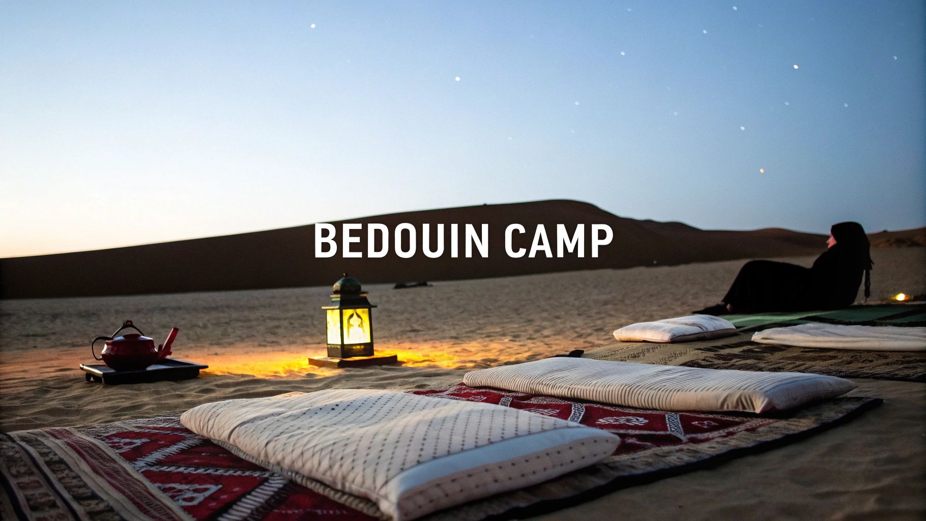 A serene Bedouin camp in the desert at night with a lantern, pillows, and a person stargazing.