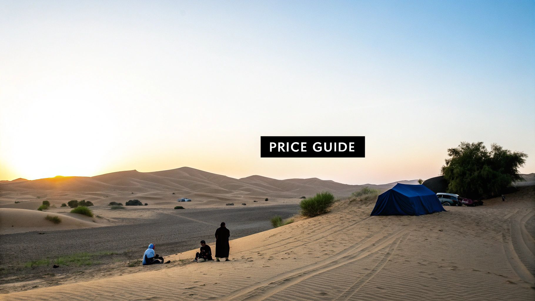 People camping in a vast desert landscape with sand dunes and a blue tent during sunset.