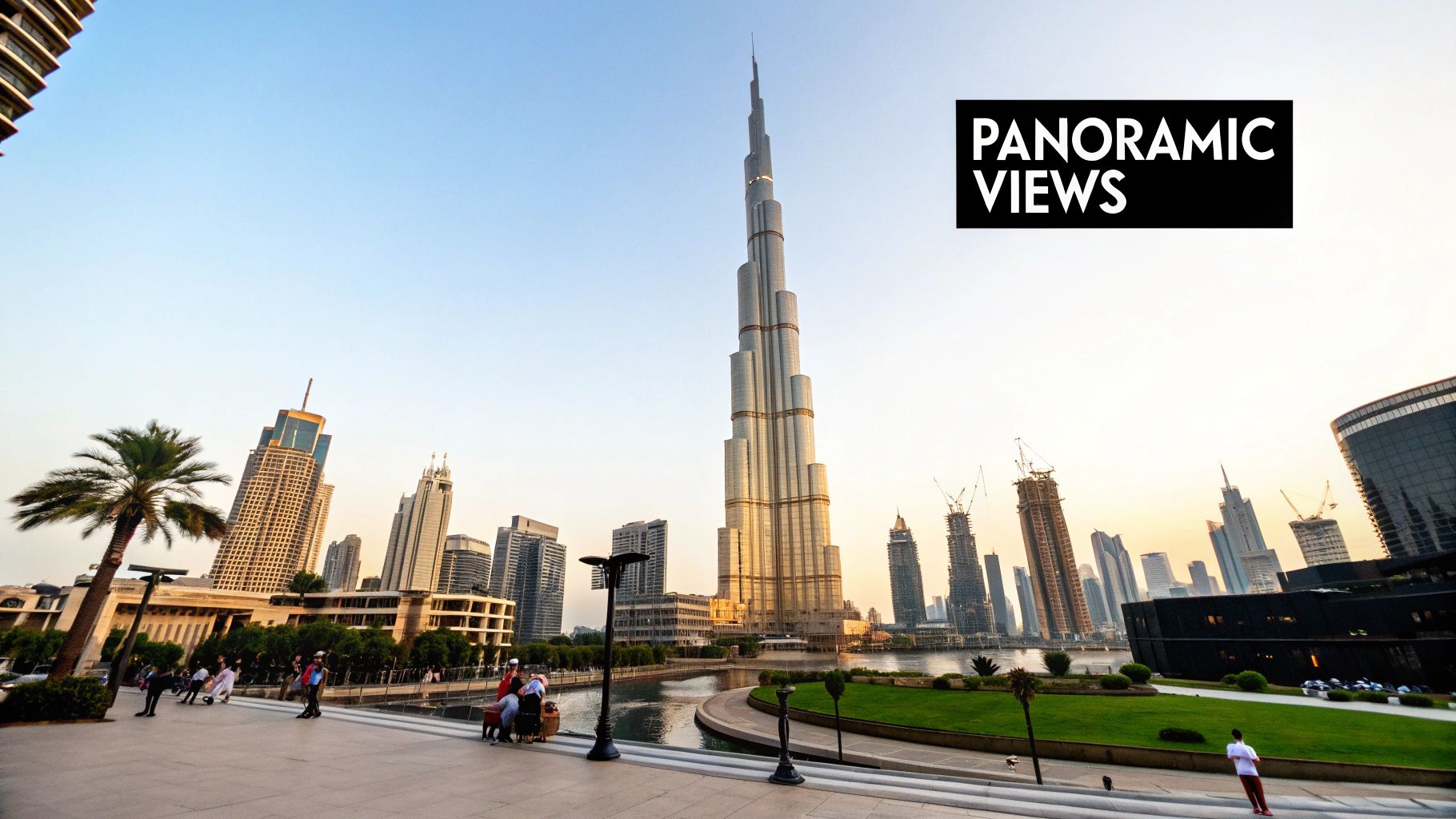 A panoramic view of Dubai featuring the iconic Burj Khalifa, other skyscrapers, and people along a waterfront promenade.