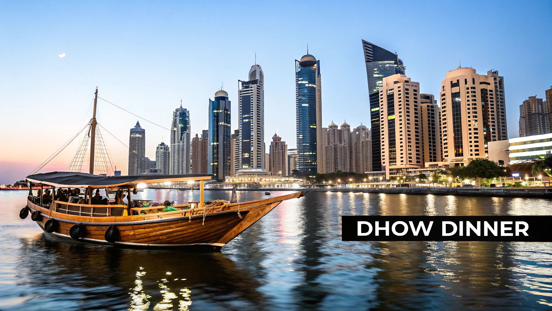 A traditional Dhow boat filled with passengers cruises along a water canal in Dubai at dusk, with towering skyscrapers in the background.