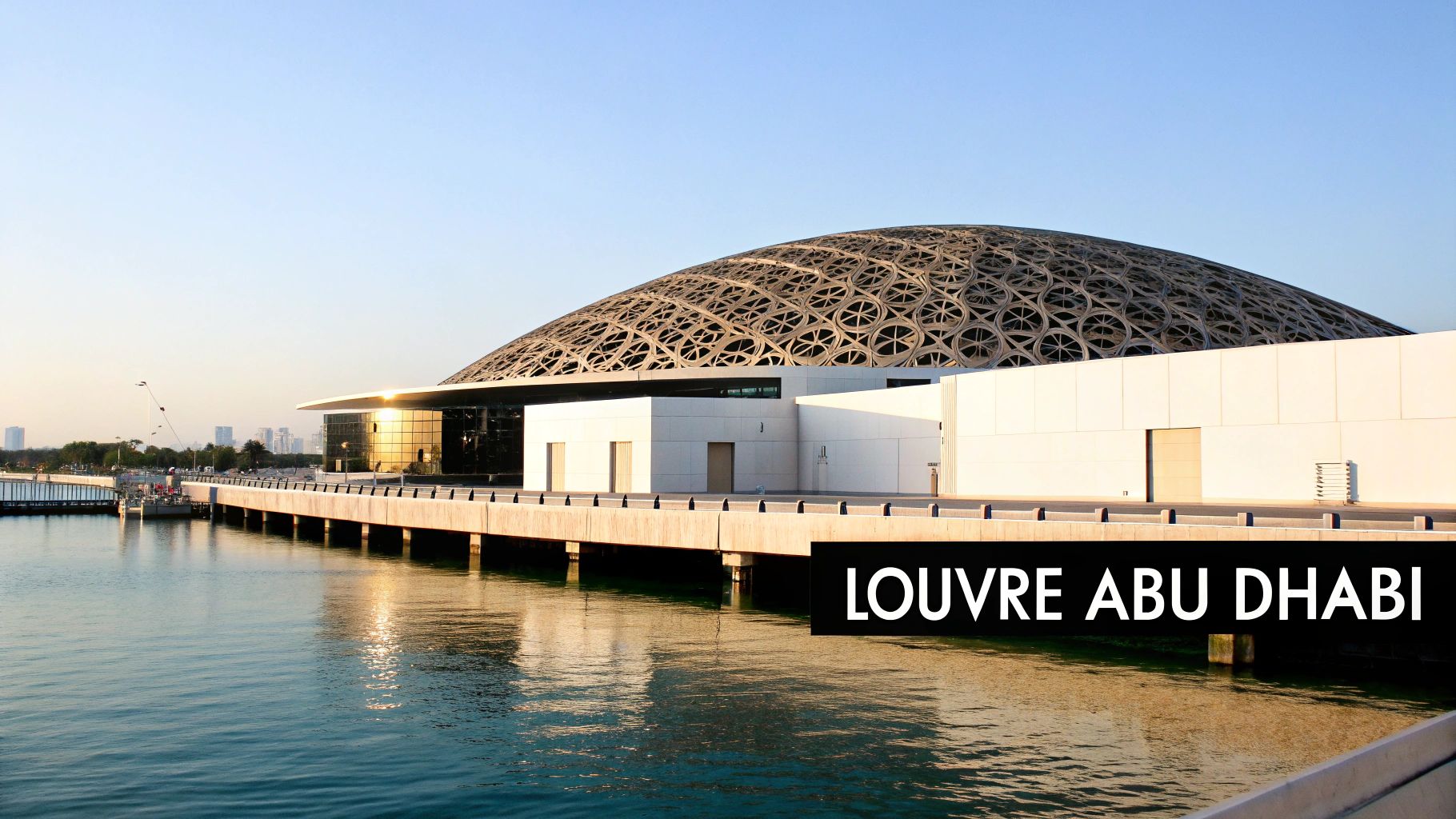 Louvre Abu Dhabi museum with iconic silver dome architecture connected by waterfront boardwalk