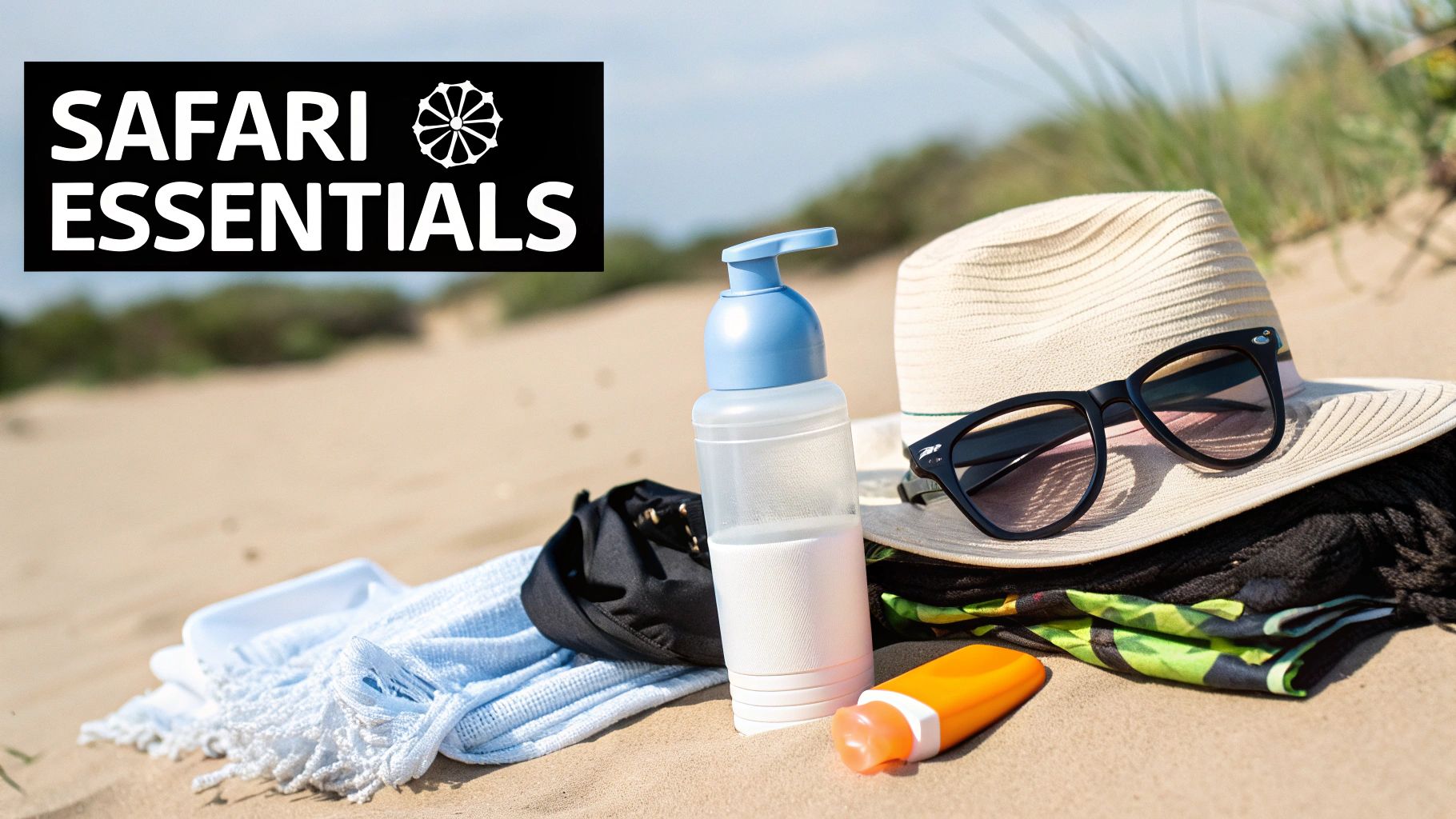 Safari essentials including a straw hat, sunglasses, sunscreen, and towels on a sandy beach.