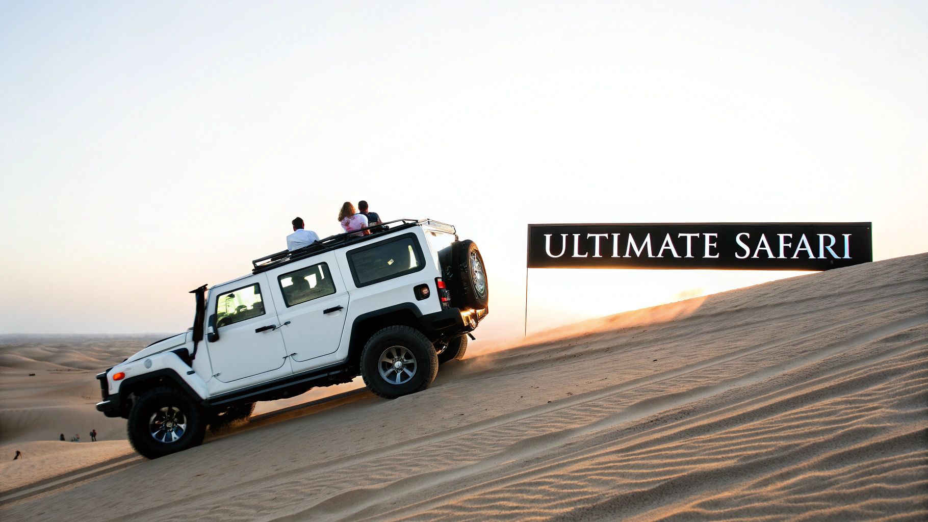 A white safari vehicle with tourists on its roof drives up a sandy dune next to an 'ULTIMATE SAFARI' sign.