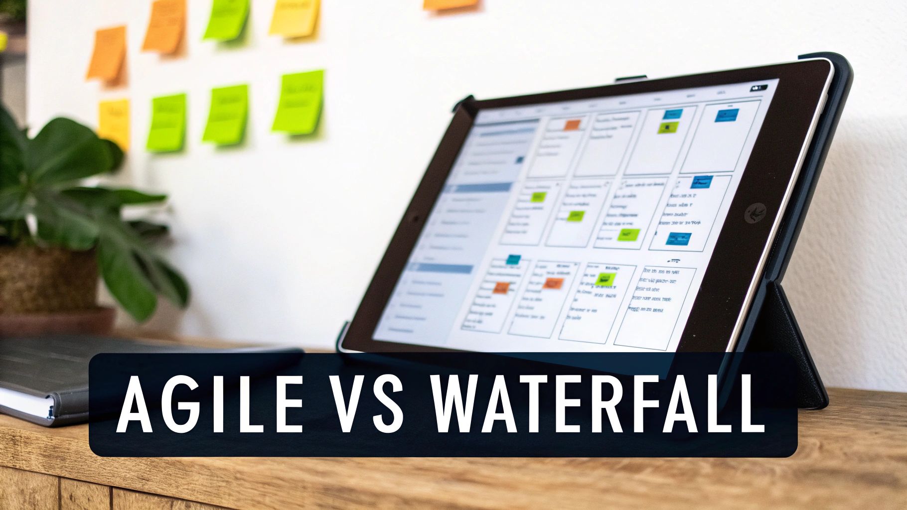 A tablet displays a digital project management board with 'Agile vs Waterfall' text, alongside physical sticky notes.