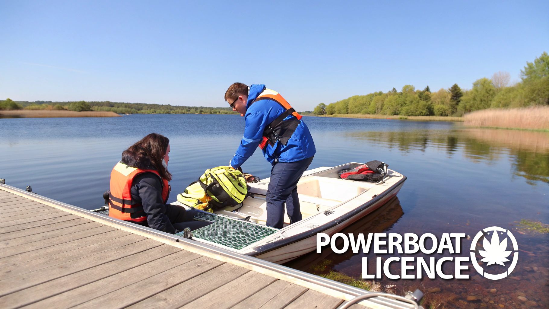 Two people in life vests on a small boat at a pier on a calm lake, preparing for powerboat training.
