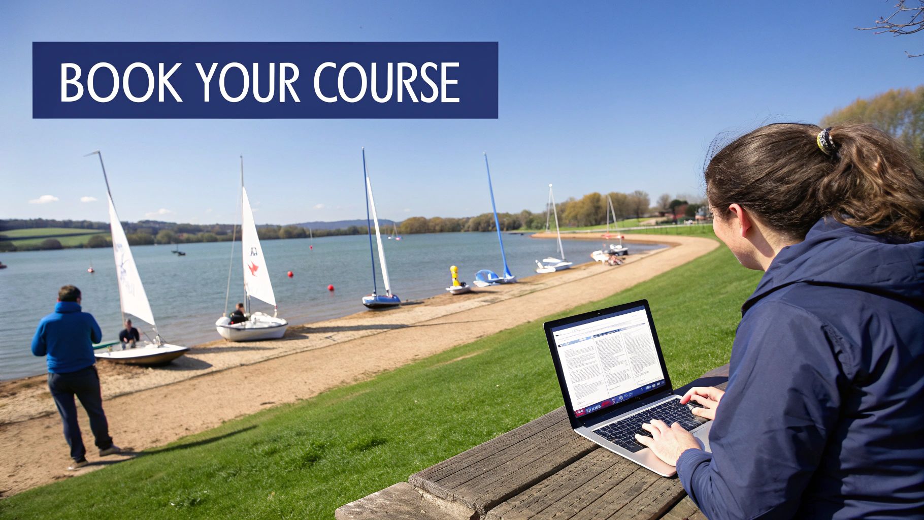 Woman typing on a laptop by a lake with sailboats, likely booking a course.