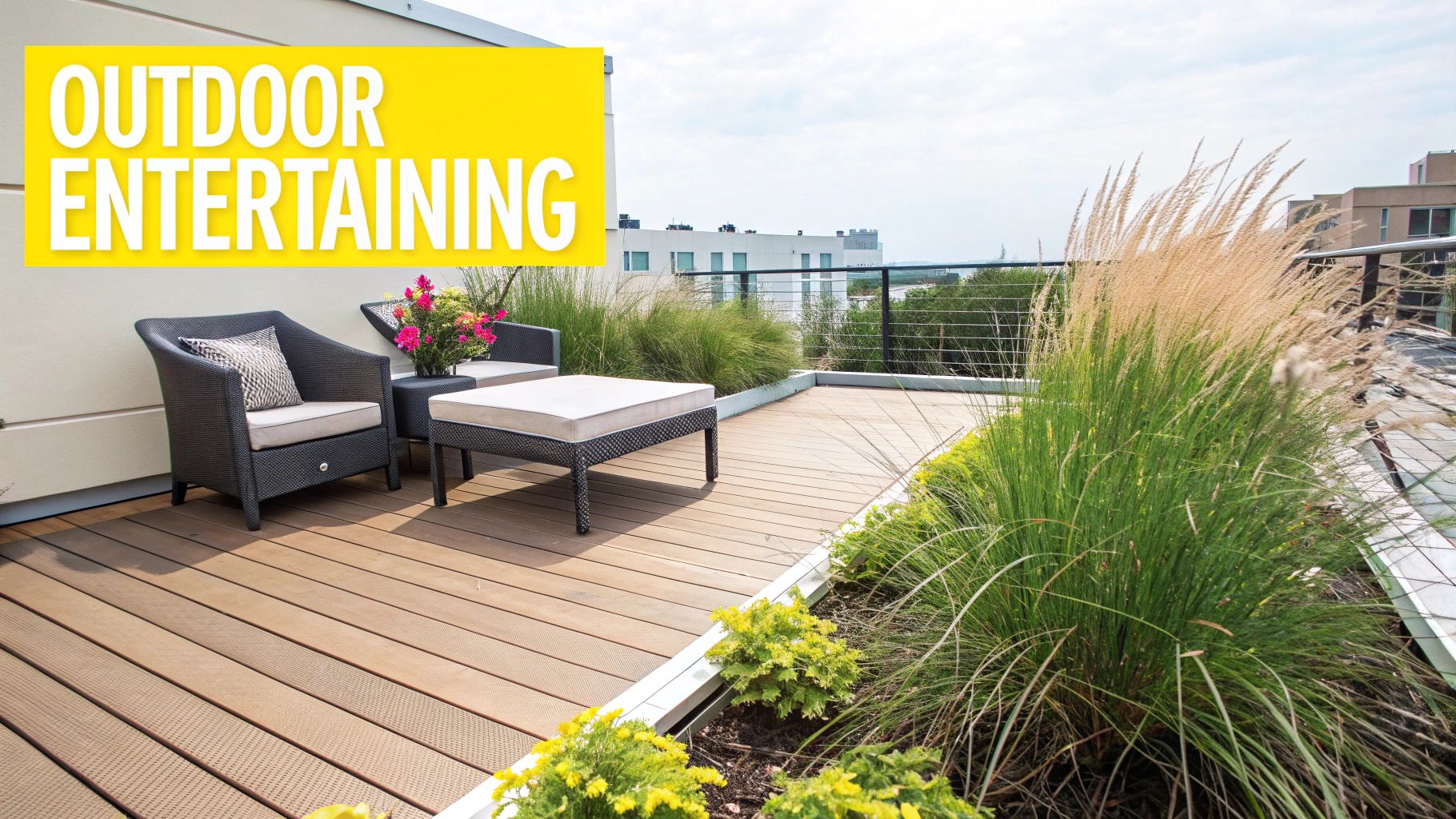 A modern rooftop patio with outdoor wicker furniture, a table, lush plants, and city buildings in the background.