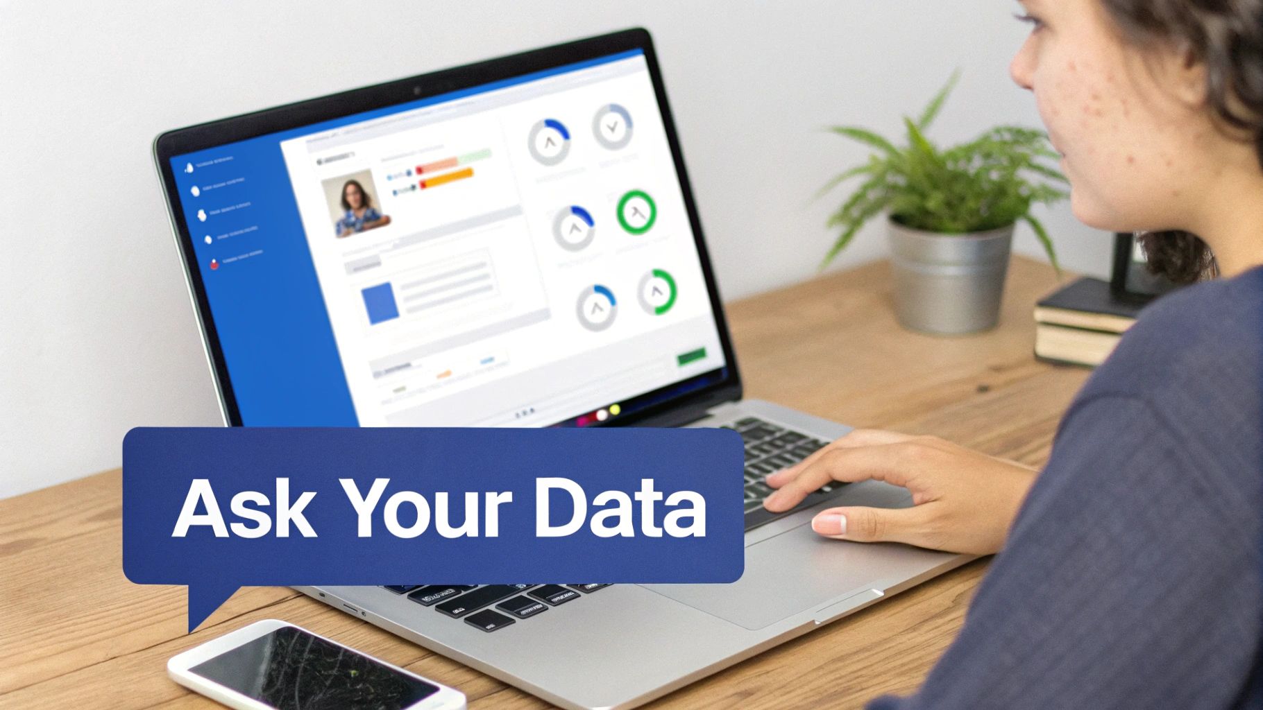 A woman uses a laptop displaying a business intelligence dashboard with data and an 'Ask Your Data' speech bubble.