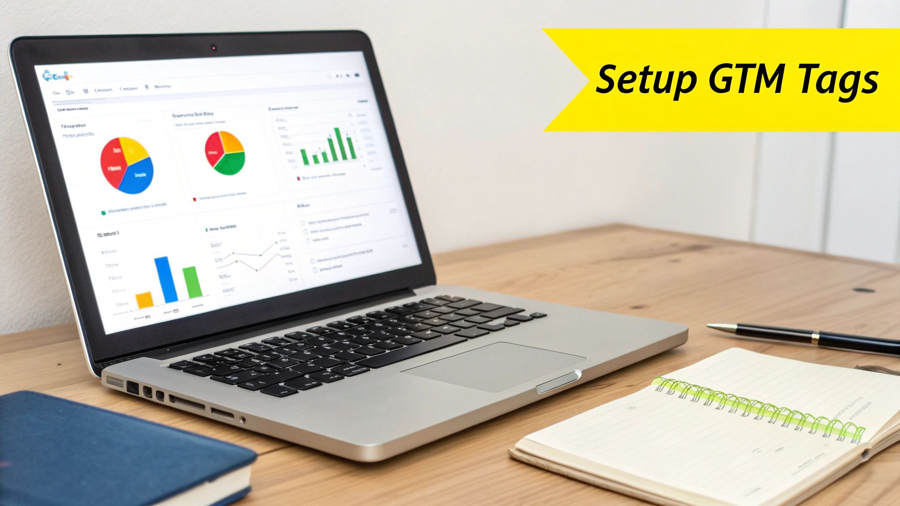 Laptop displaying analytics dashboard with charts and graphs, next to a notebook, pen, and a banner saying 'Setup GTM Tags'.