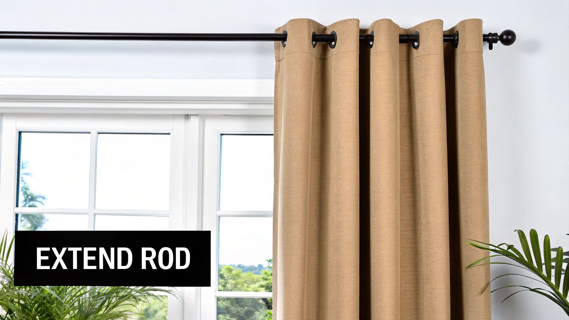A beige curtain hangs on a black extendable rod above a white window frame.