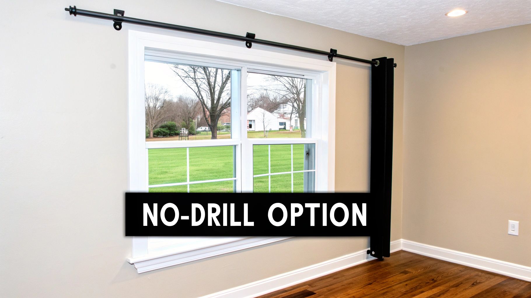 A room with light walls and a window featuring a black no-drill curtain rod and a black curtain.