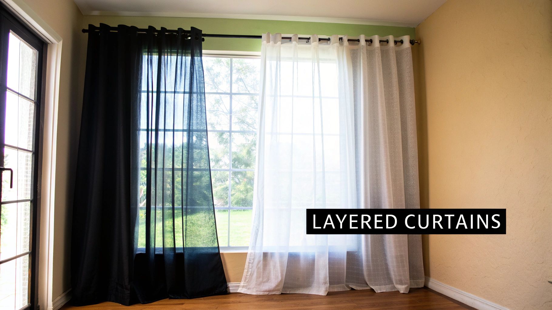 Window with layered black and white sheer curtains on a double curtain rod.