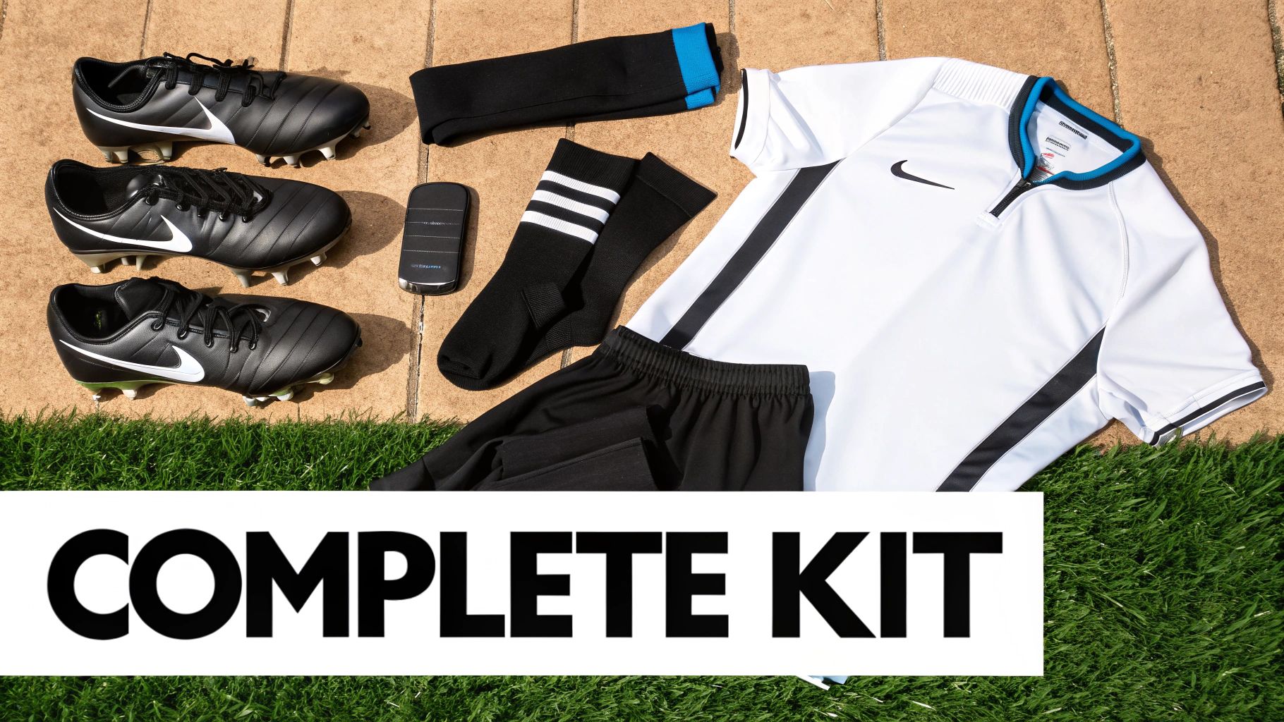 A complete black and white Nike football kit including three pairs of boots, shirt, shorts, socks, and shinguards laid out.