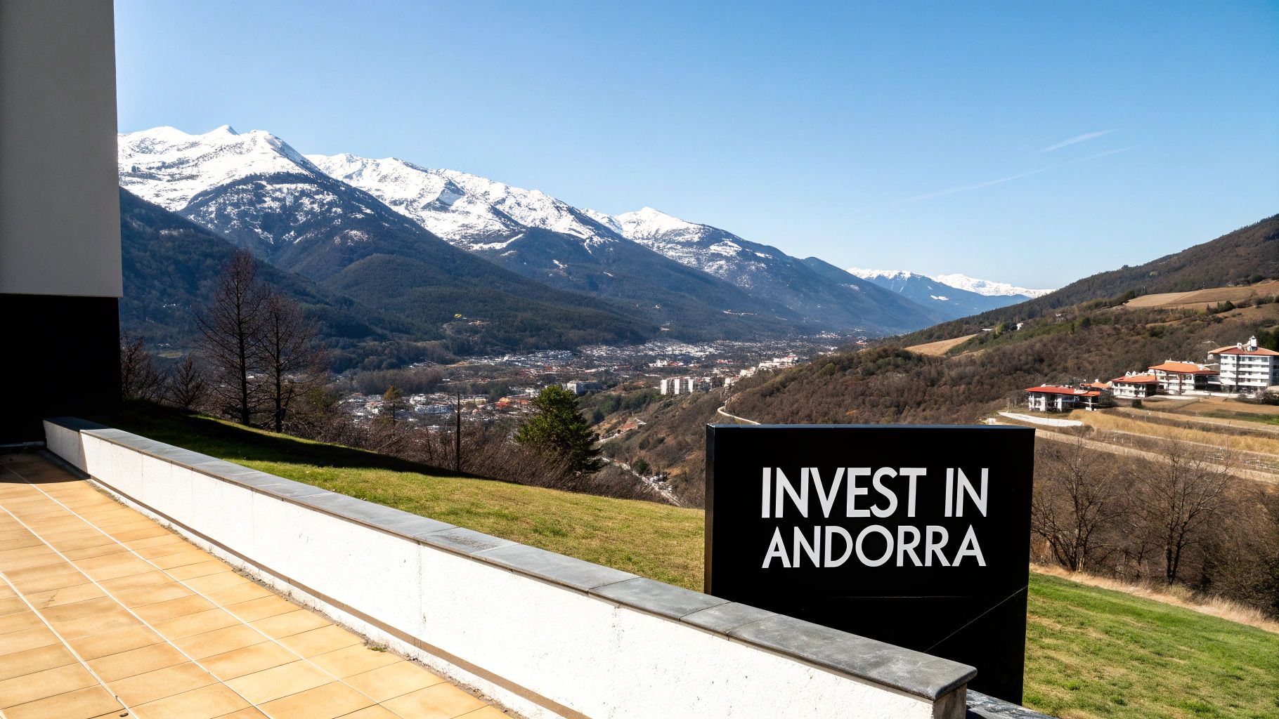 Luxury property terrace overlooking snow-capped Andorran mountains with invest in Andorra sign