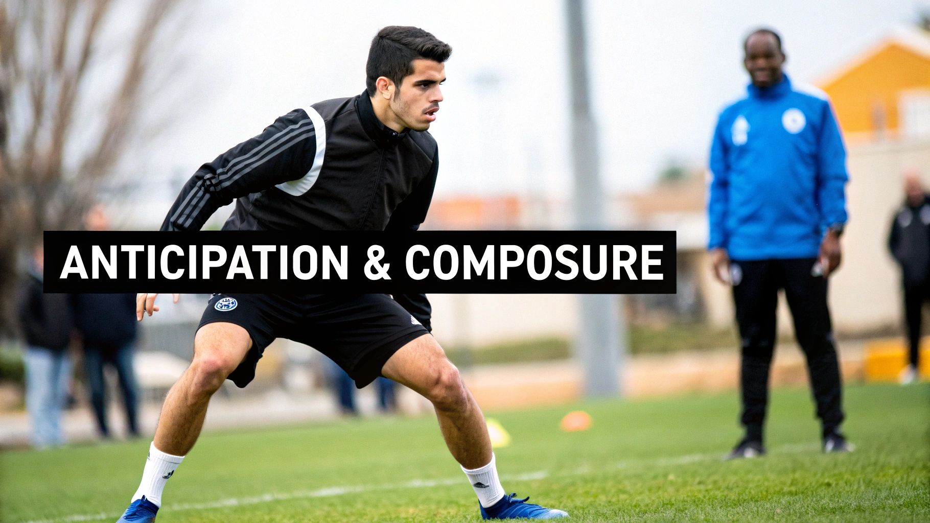 Soccer player in black training gear demonstrates anticipation and composure during drills on a green field.