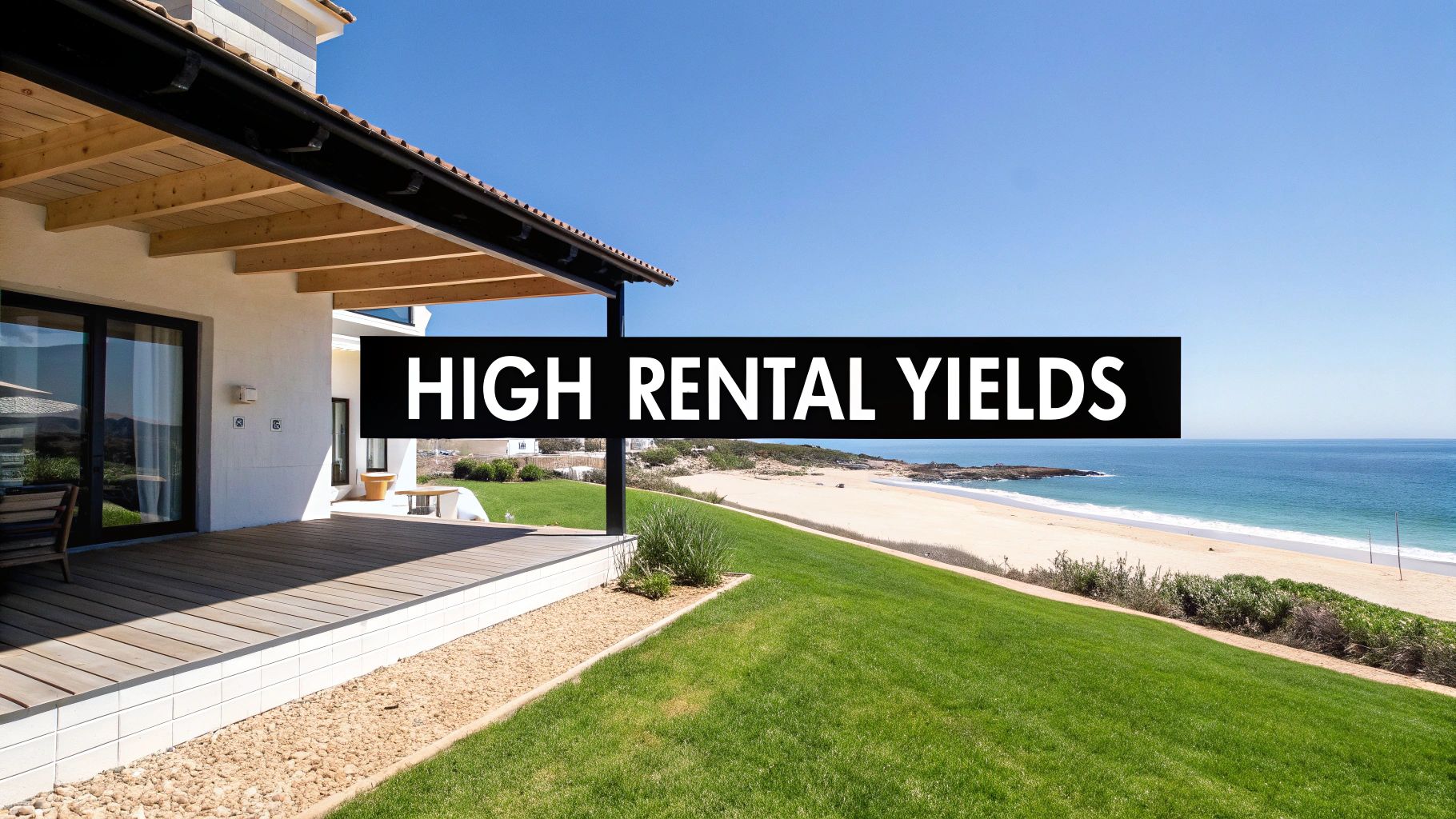 A modern house with a deck and green lawn overlooking a serene beach and ocean, with 'HIGH RENTAL YIELDS' overlay.