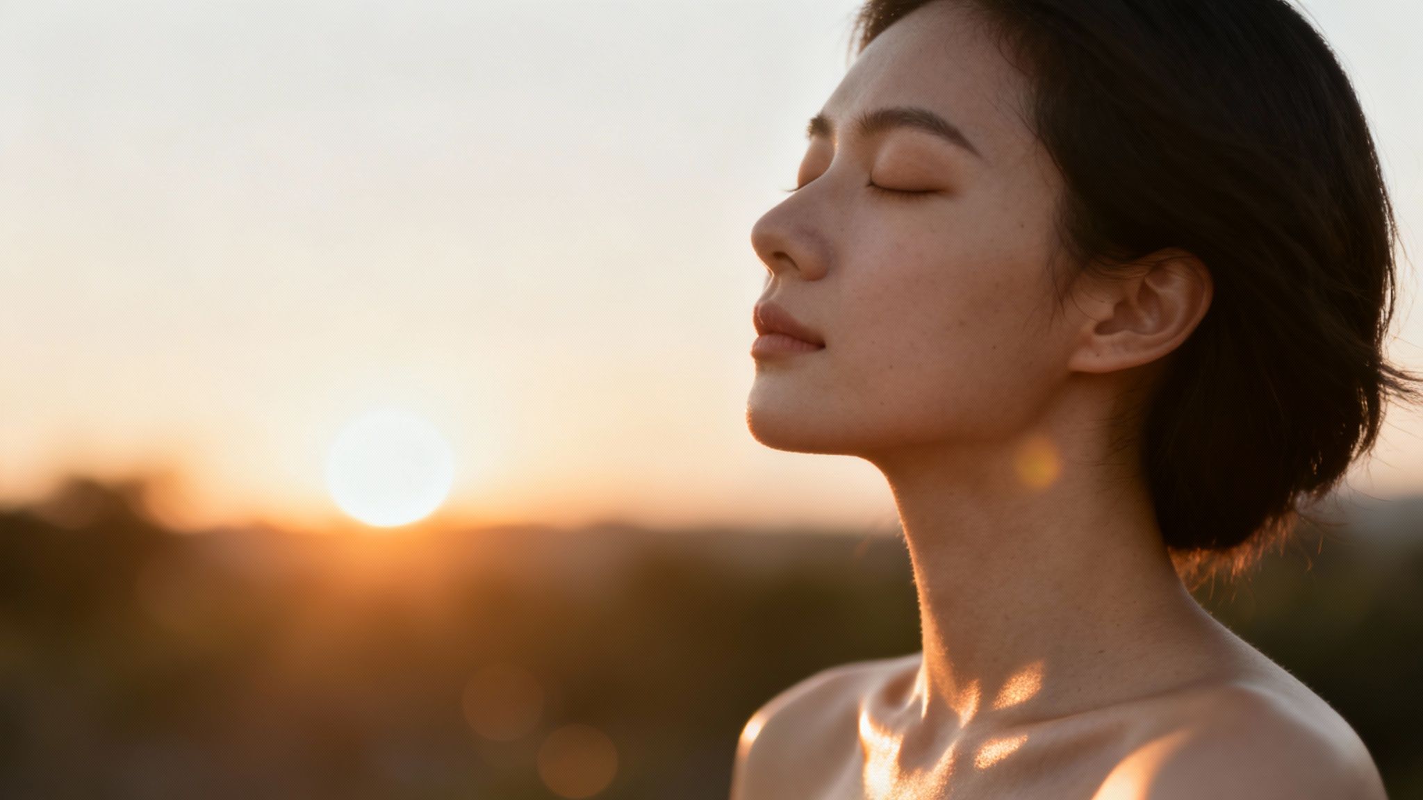 Woman enjoying the sunshine in a field, representing the 'sunshine vitamin'.