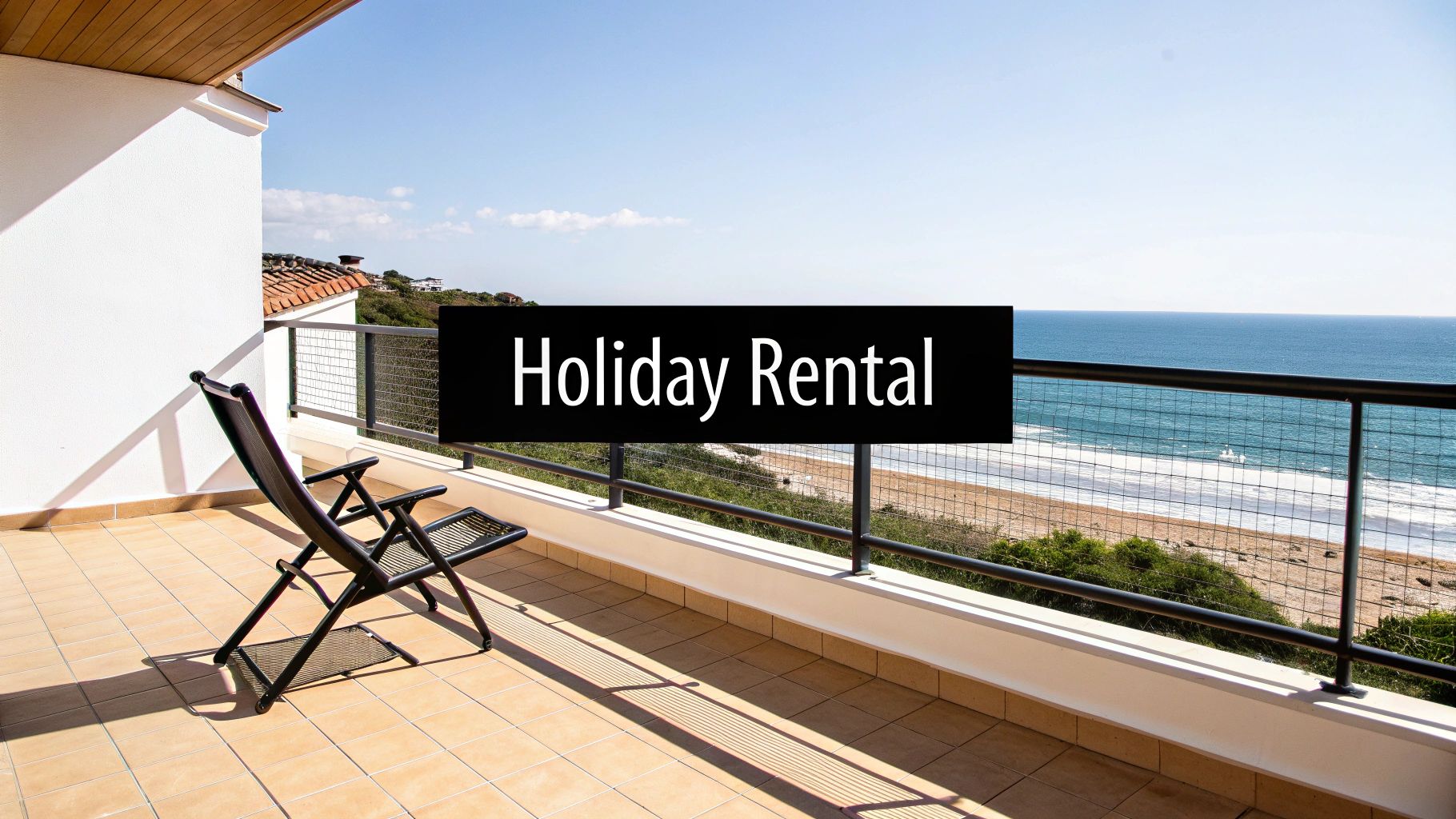 A sunny balcony with a lounge chair offers stunning ocean and beach views, perfect for a holiday rental.