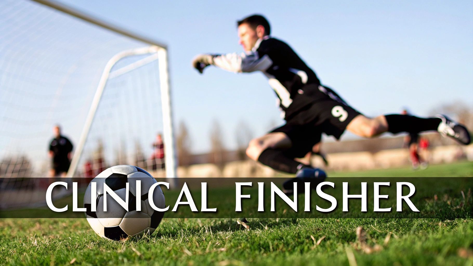 A soccer goalie dives mid-air to save a goal, with a ball on green grass in the foreground.