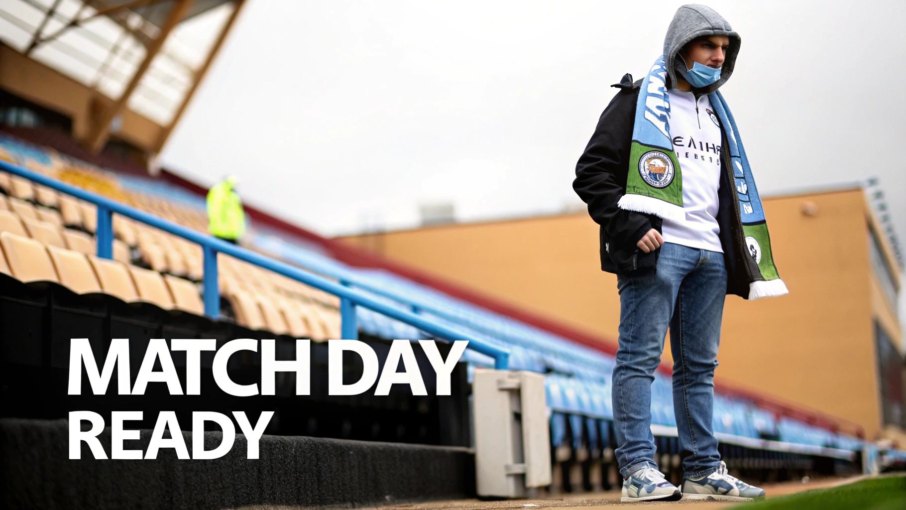 A football fan wearing a Manchester City scarf and face mask stands ready on match day.