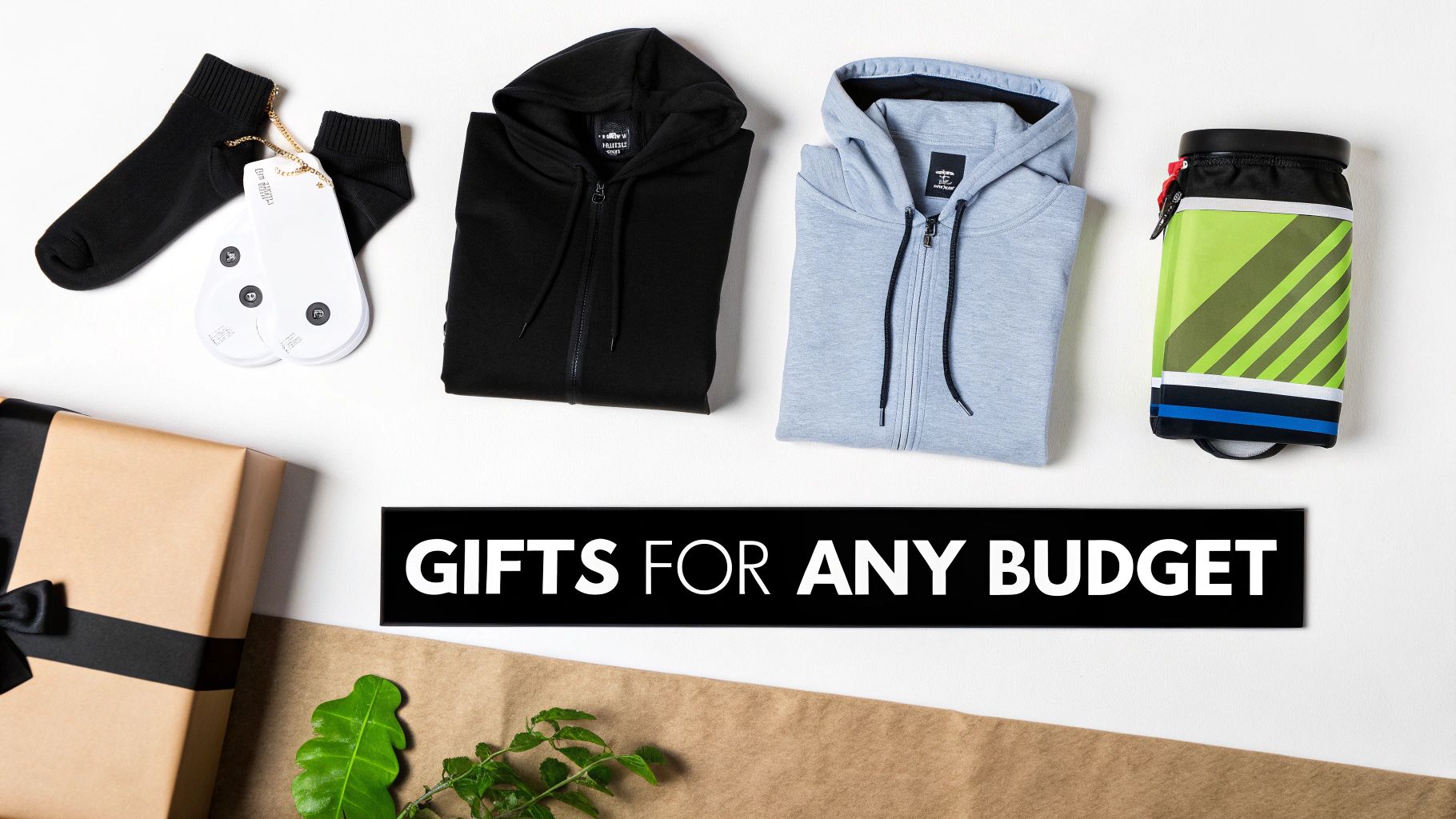 A flat lay of various gifts, including black socks, two hoodies, a water bottle, and a wrapped gift box, on a white background with a 'Gifts for any budget' sign.