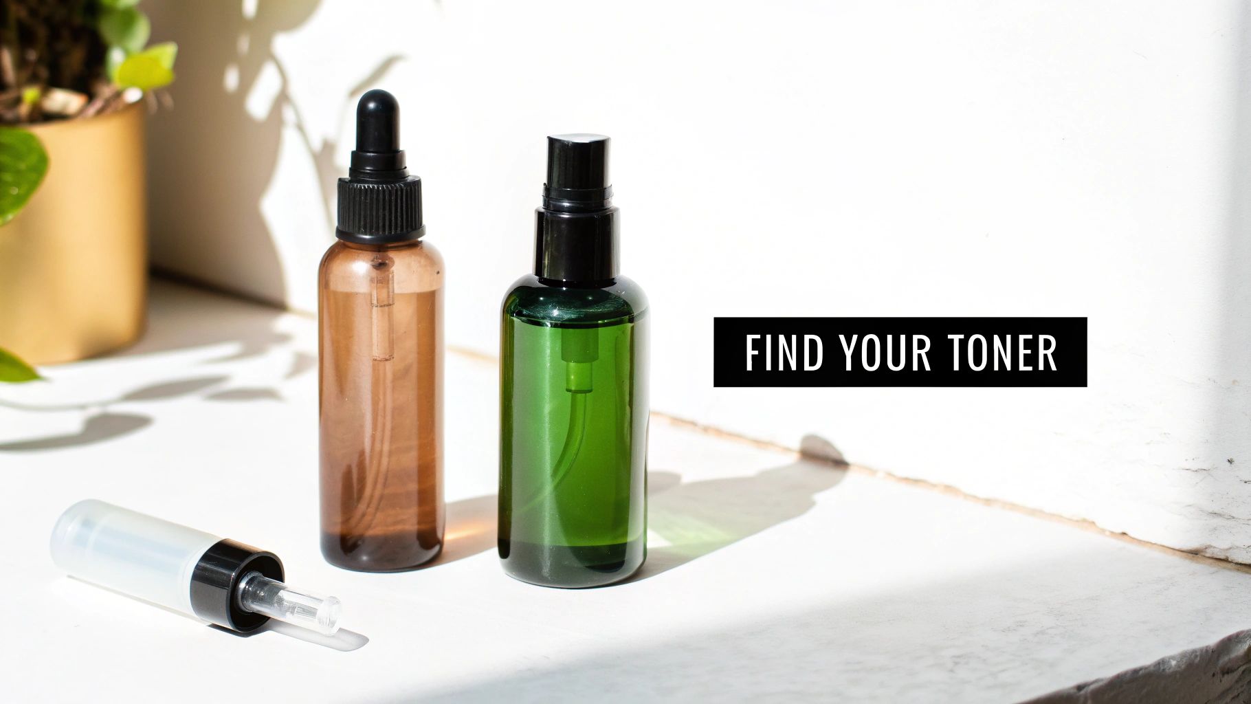 Two different toner bottles, one brown dropper and one green spray, with a dispenser on a white surface.