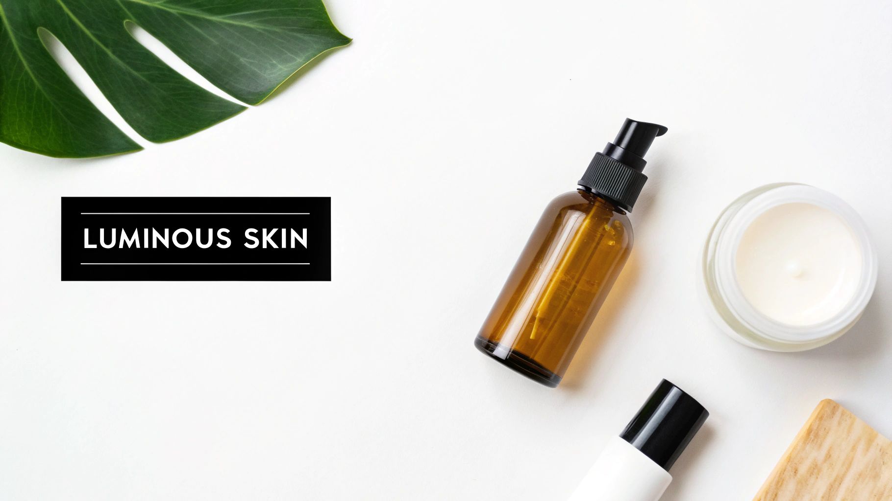 Overhead flatlay of natural skincare products, a Monstera leaf, and 'Luminous Skin' text on white.