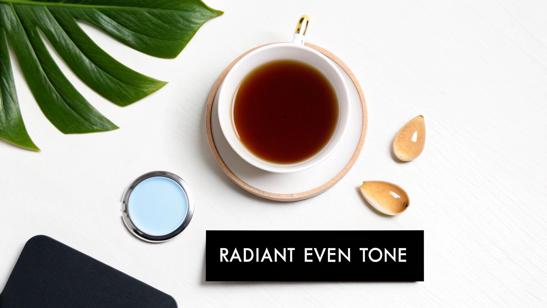 Flat lay of a cup of black tea, green leaf, and skincare products with 'Radiant Even Tone' text.