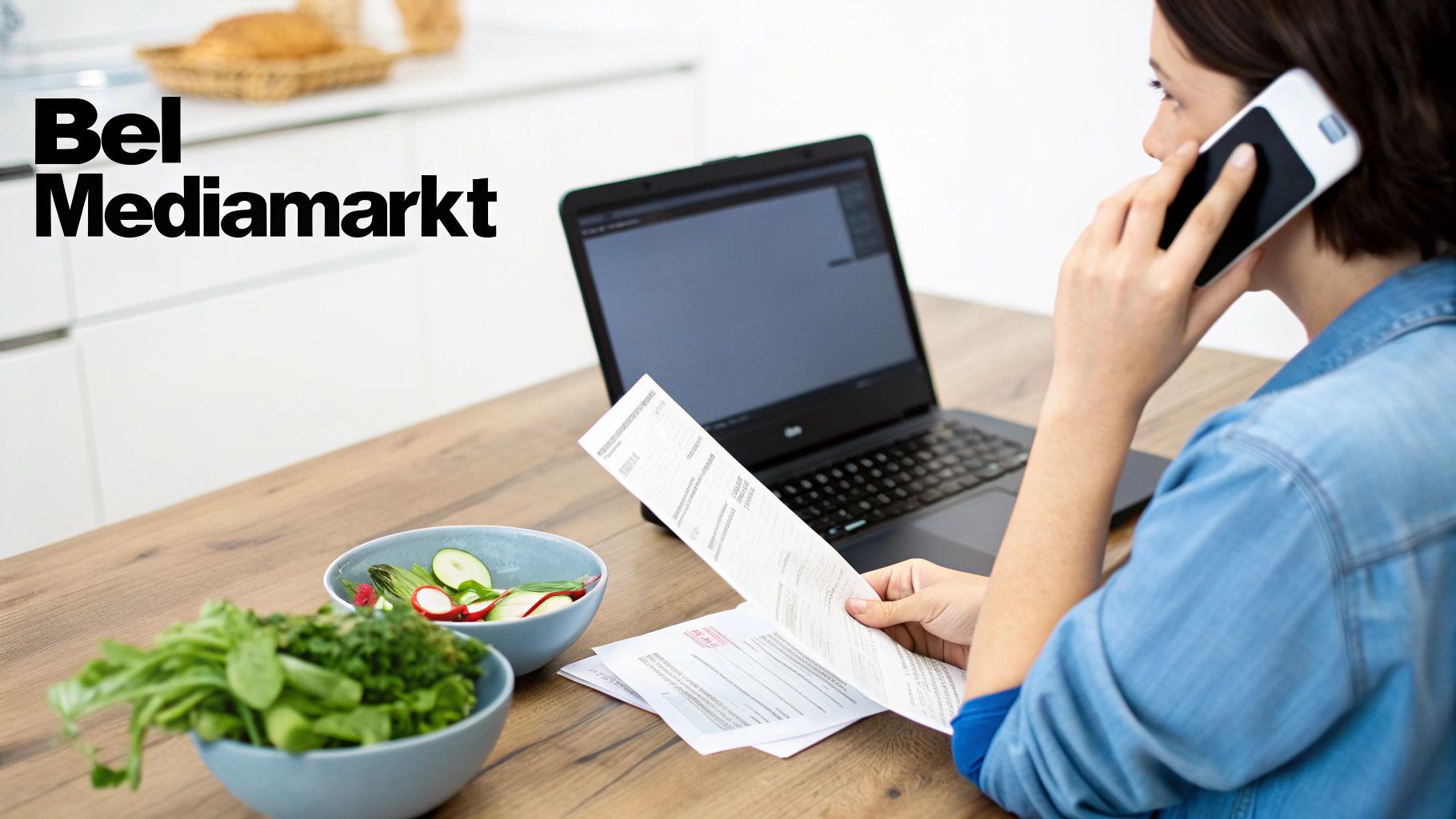 Een persoon belt met Mediamarkt, houdt documenten vast en gebruikt een laptop aan een houten tafel.