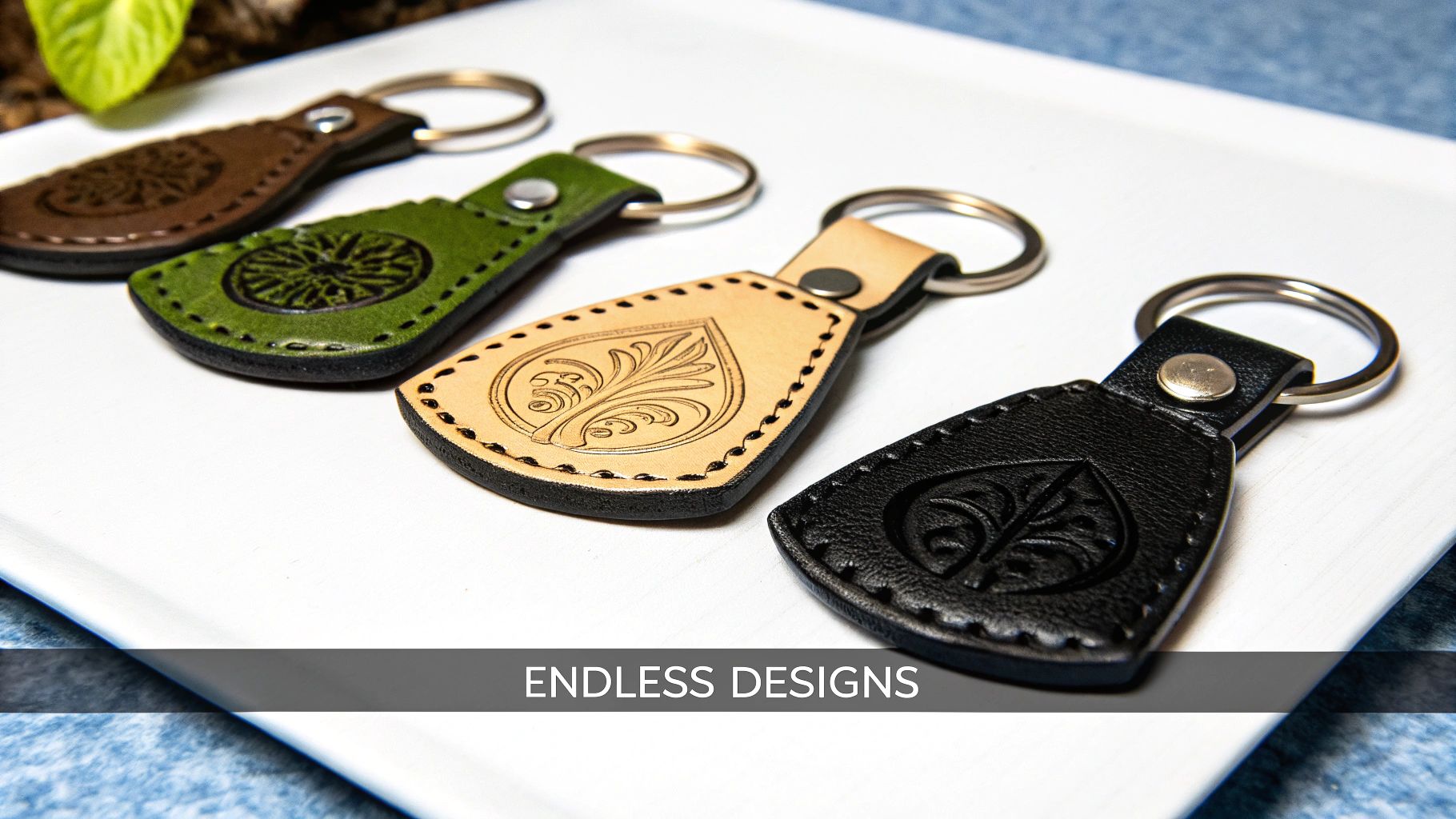 Custom leather keychains in various colors featuring intricate designs, showcasing the precision of laser engraving technology, with the text "ENDLESS DESIGNS" displayed prominently.
